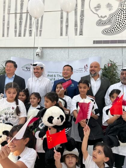 Group photo of high officials and children celebrating the arrival of the giant pandas in qatar