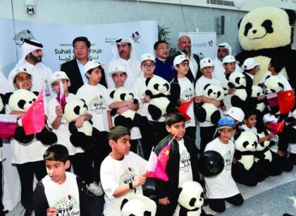 Group photo of high officials and children celebrating the arrival of the giant pandas in qatar